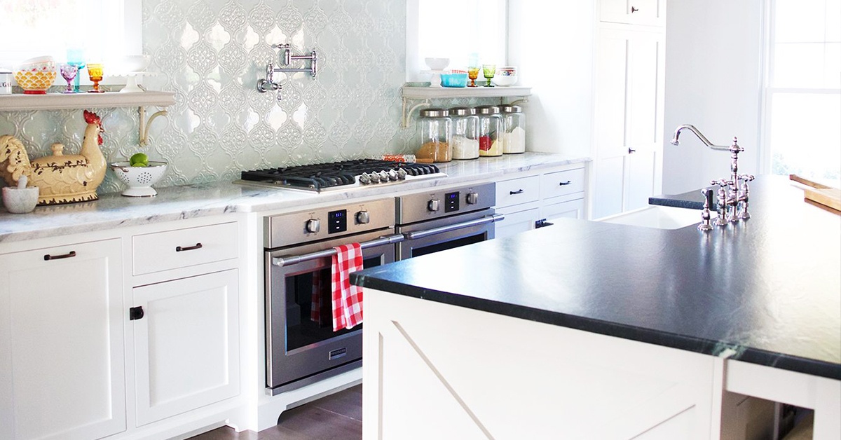 White marble kitchen counter top with a stove in a modern home