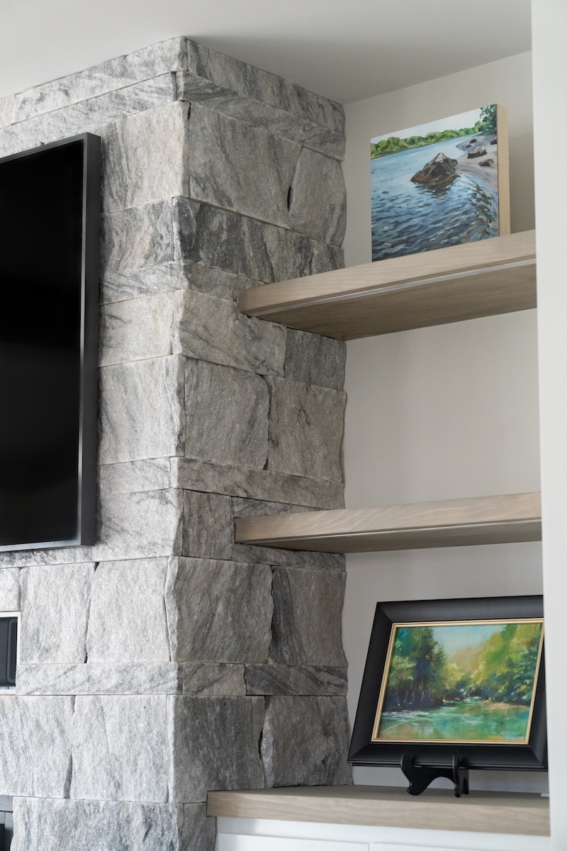 Berkshire™ Georgia Marble Pearl Grey split-face marble veneer fireplace column and corner — full height veneer installation with natural light and built-in open shelving, coastal New England interior