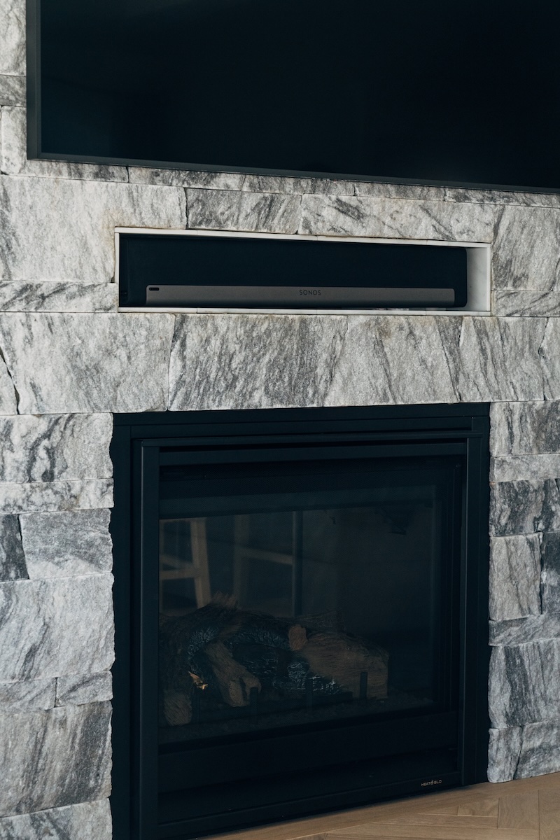 Berkshire™ Georgia Marble Pearl Grey split-face veneer fireplace — full surround view showing varied coursing pattern and natural grey and white veining, interior residential installation