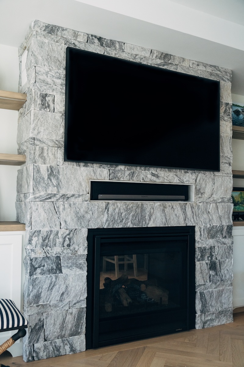 Berkshire™ Georgia Marble Pearl Grey split-face veneer fireplace — full surround view showing varied coursing pattern and natural grey and white veining, interior residential installation
